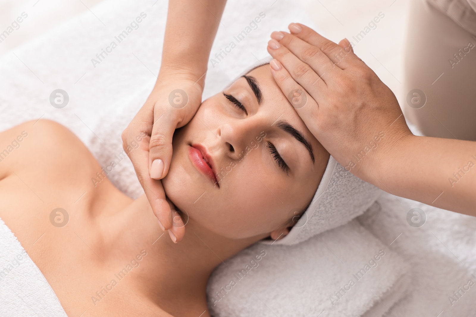 Photo of Attractive woman enjoying face massage, closeup. Beauty procedure