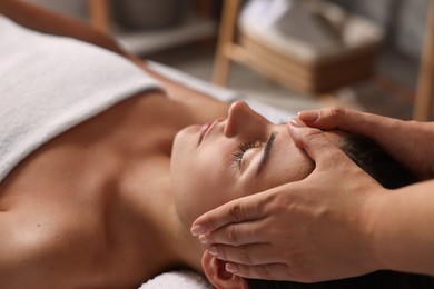 Attractive woman enjoying face massage, closeup. Beauty procedure