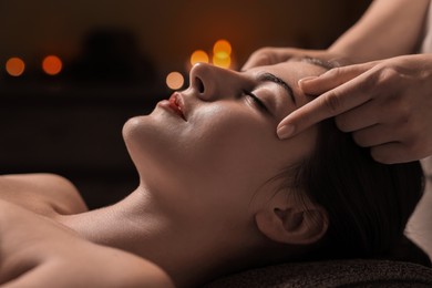 Attractive woman enjoying face massage, closeup. Beauty procedure