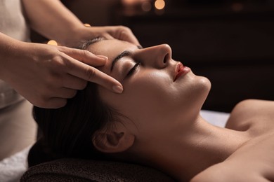 Photo of Attractive woman enjoying face massage, closeup. Beauty procedure