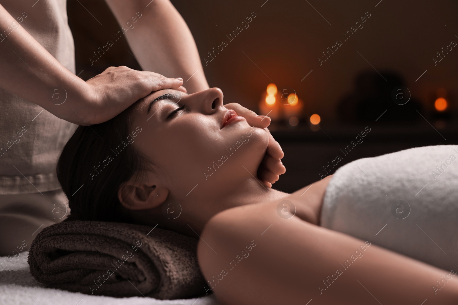 Photo of Attractive woman enjoying face massage, closeup. Beauty procedure