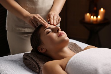 Photo of Attractive woman enjoying face massage, closeup. Beauty procedure