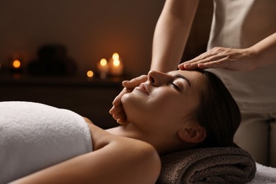 Photo of Attractive woman enjoying face massage, closeup. Beauty procedure