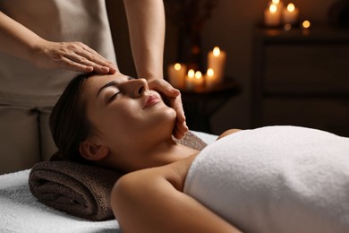 Photo of Attractive woman enjoying face massage, closeup. Beauty procedure