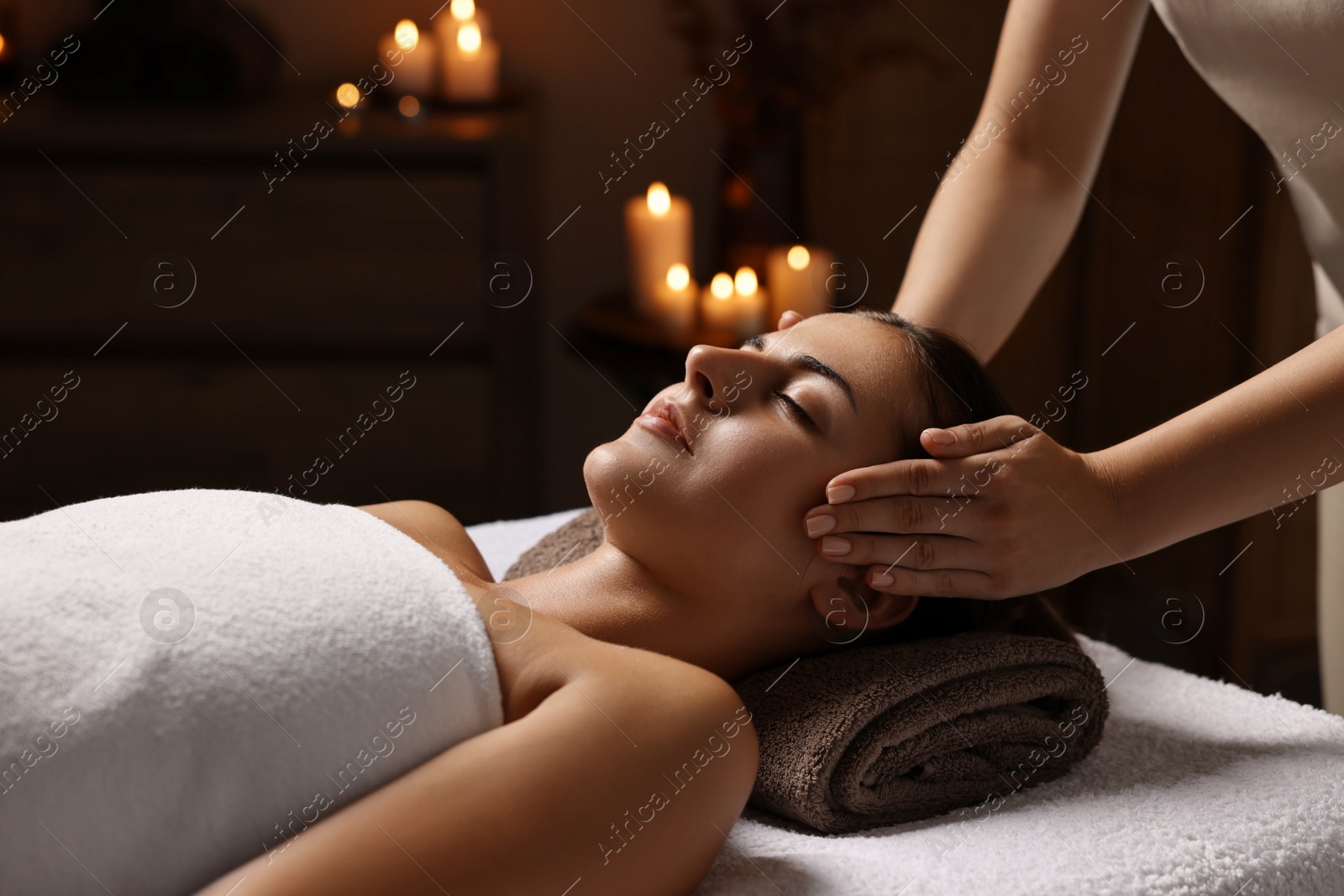 Photo of Attractive woman enjoying face massage, closeup. Beauty procedure