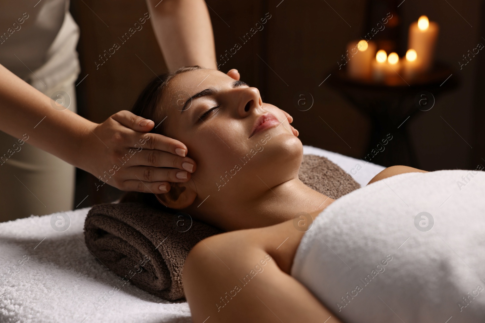 Photo of Attractive woman enjoying face massage, closeup. Beauty procedure