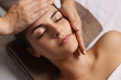 Attractive woman enjoying face massage, above view. Beauty procedure