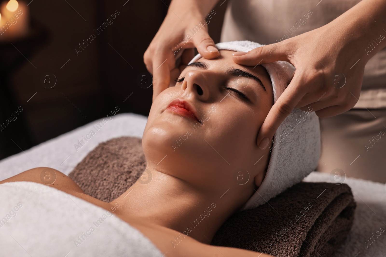 Photo of Attractive woman enjoying face massage, closeup. Beauty procedure