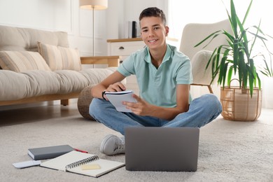 Photo of Portrait of happy teenage boy at home