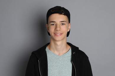 Photo of Portrait of teenage boy on grey background