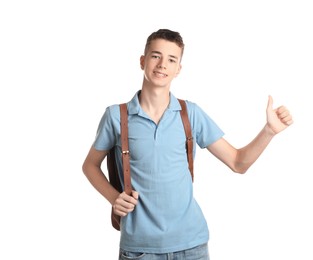 Photo of Portrait of teenage boy with backpack showing thumbs up on white background