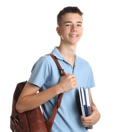 Portrait of teenage boy with backpack and books on white background