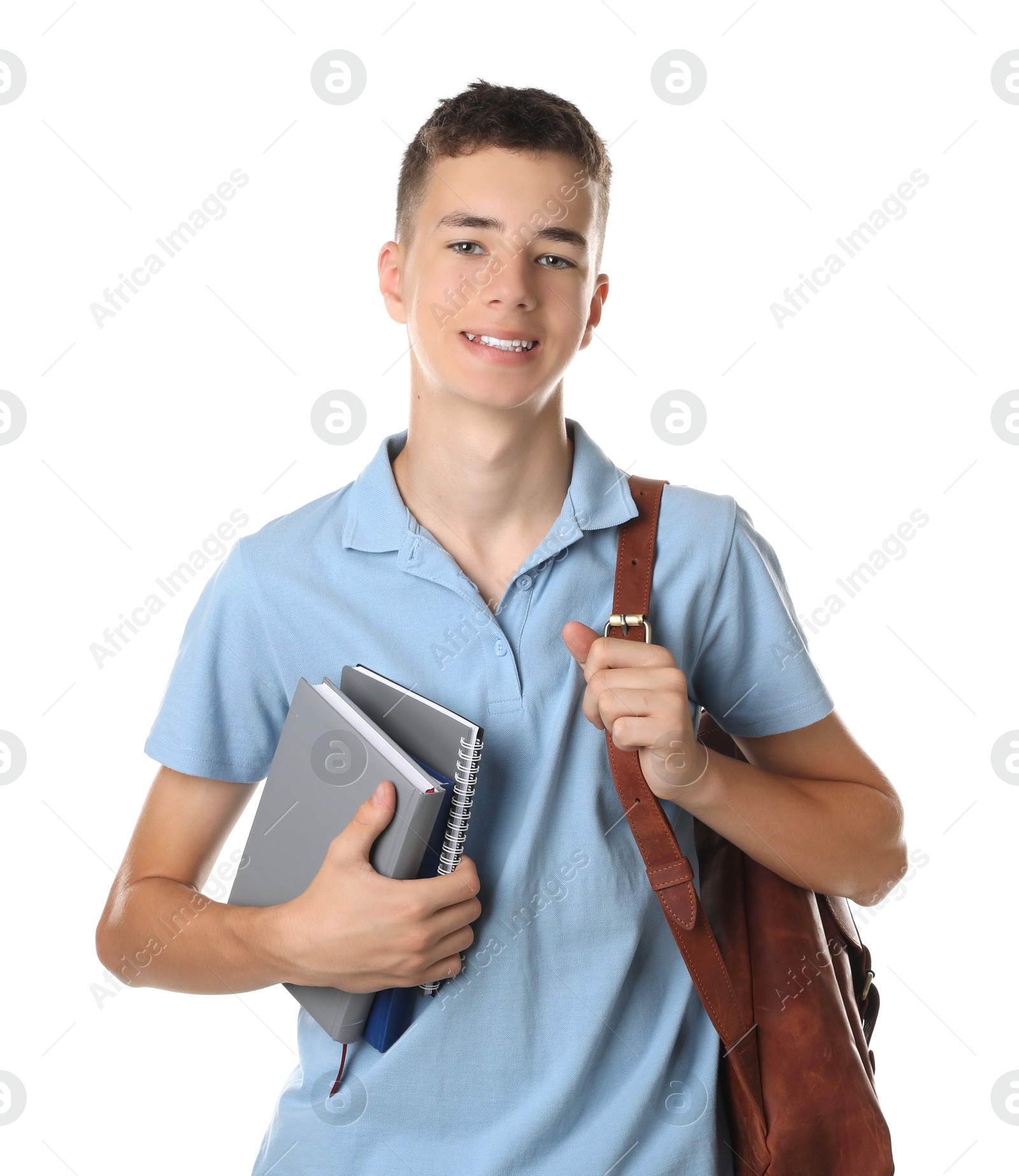 Photo of Portrait of teenage boy with backpack and books on white background