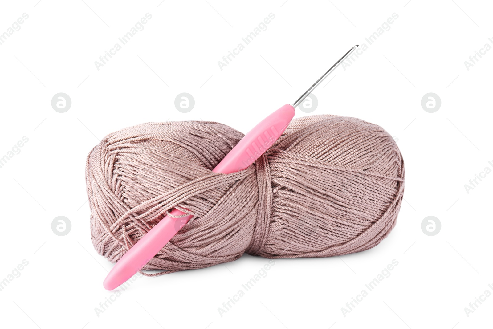 Photo of Skein of light brown yarn and crochet hook isolated on white