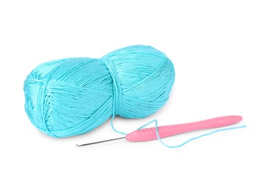 Photo of Skein of light blue yarn and crochet hook isolated on white