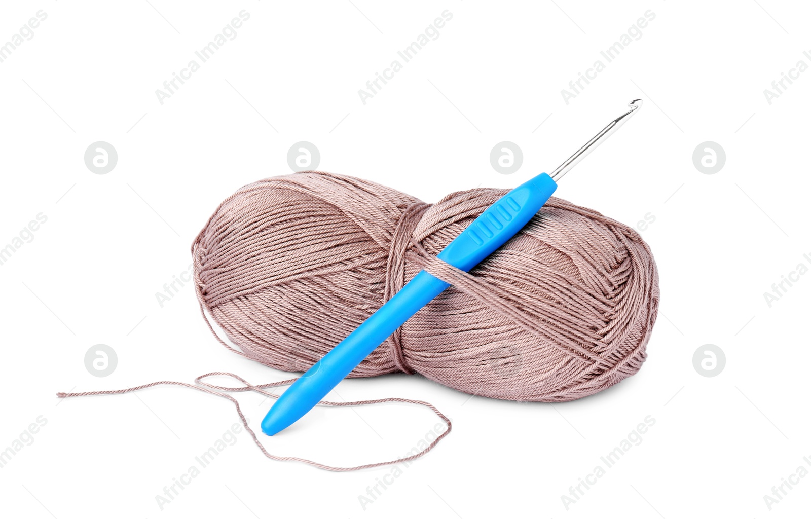 Photo of Skein of light brown yarn and crochet hook isolated on white