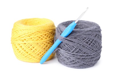 Photo of Threads of colorful yarns and crochet hook isolated on white