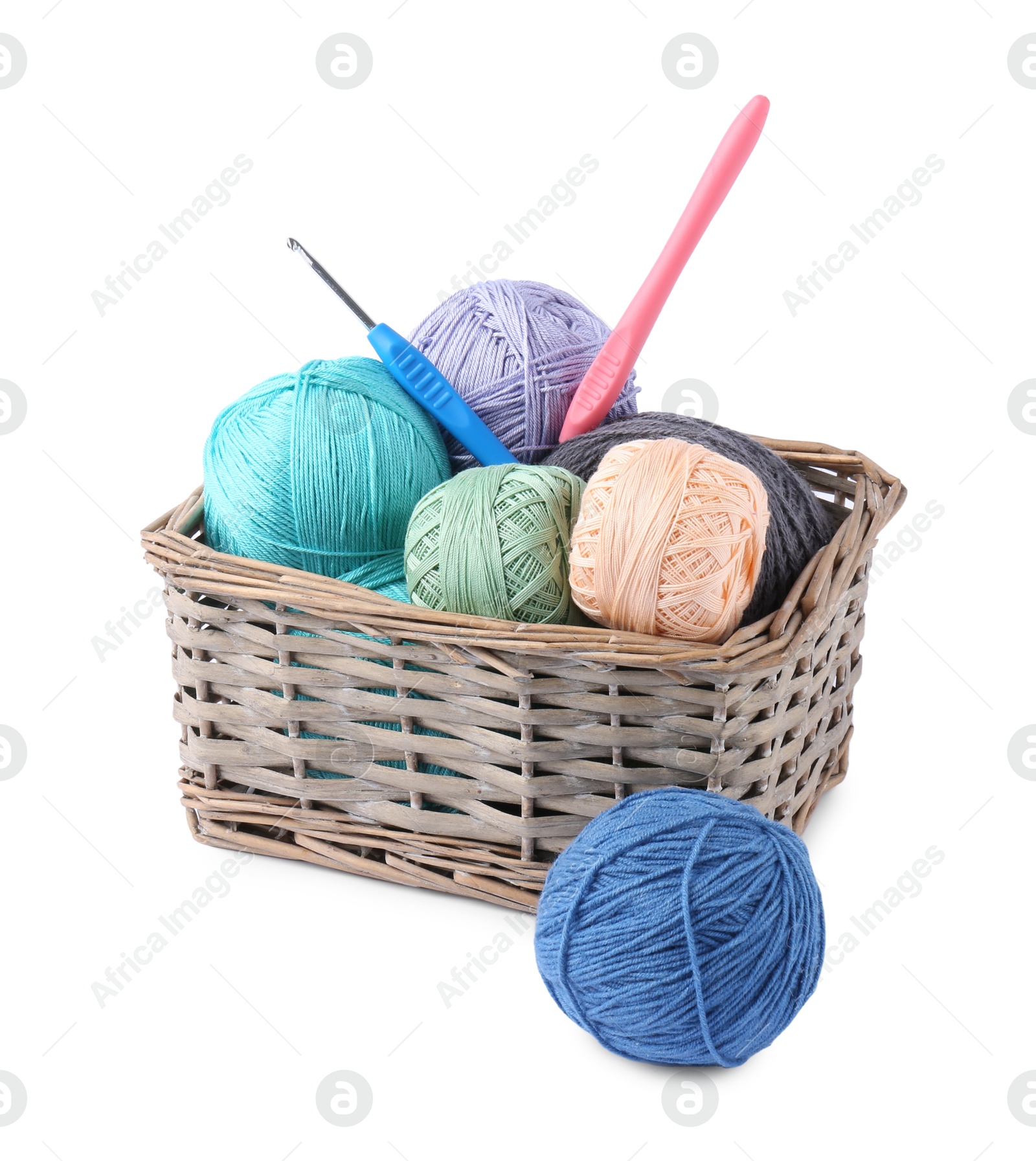 Photo of Many colorful yarns and crochet hooks in wicker basket isolated on white