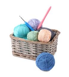 Photo of Many colorful yarns and crochet hooks in wicker basket isolated on white