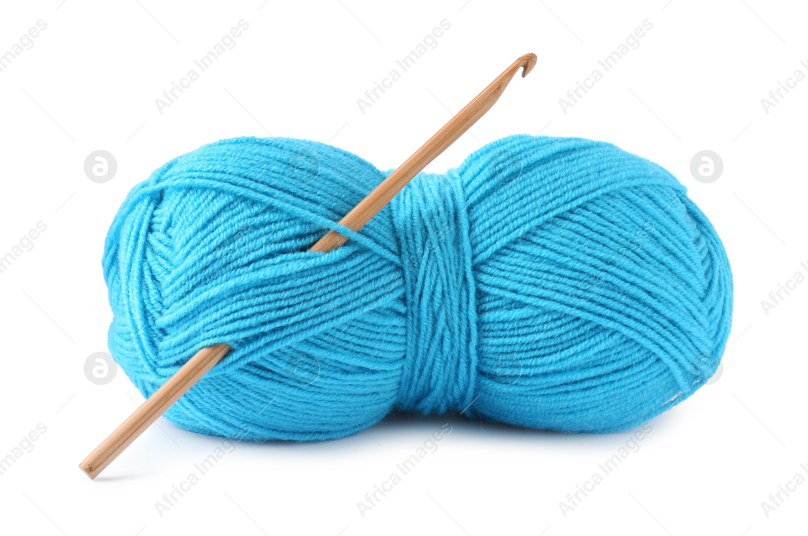 Photo of Light blue skein of yarn and crochet hook isolated on white