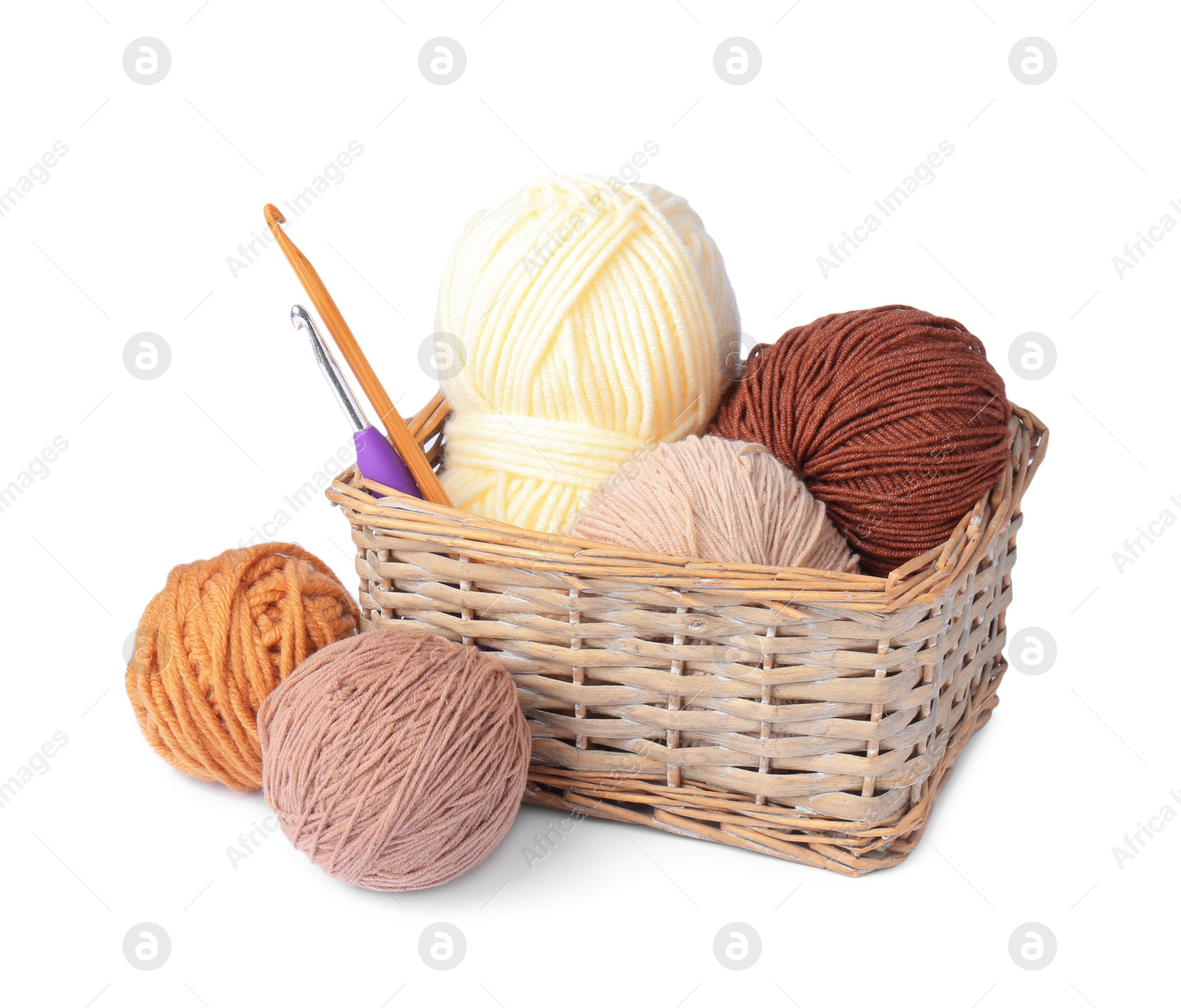 Photo of Colorful yarns and crochet hooks in wicker basket isolated on white