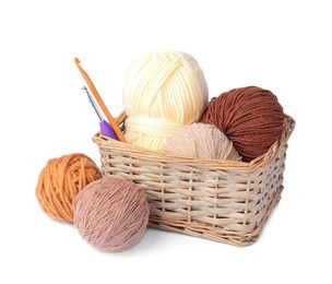 Photo of Colorful yarns and crochet hooks in wicker basket isolated on white