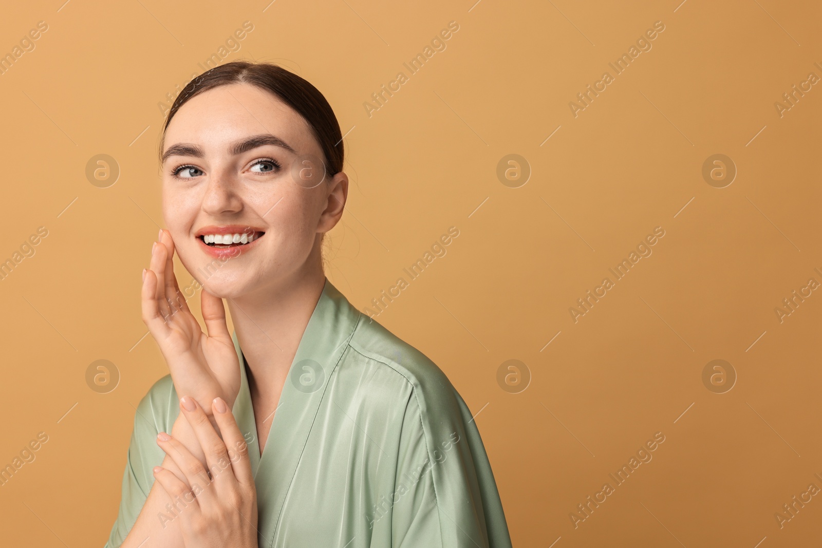 Photo of Beautiful young woman with healthy skin on beige background, space for text