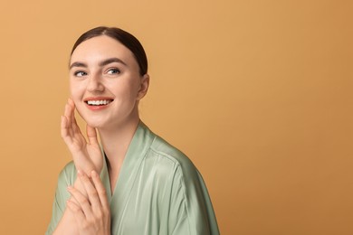 Beautiful young woman with healthy skin on beige background, space for text