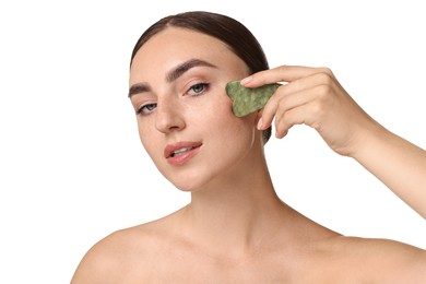 Beautiful young woman doing facial massage with gua sha tool on white background