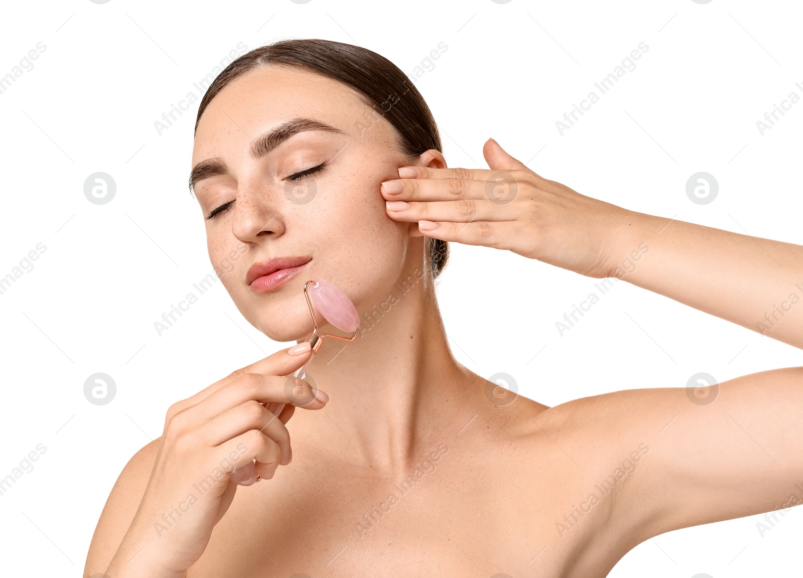 Photo of Beautiful young woman doing facial massage with roller on white background