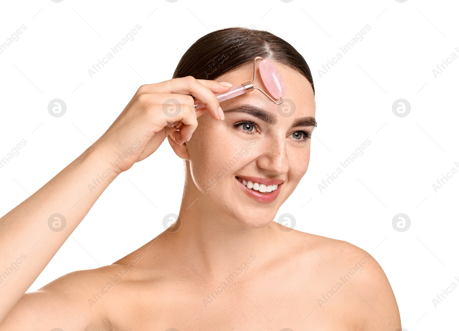 Photo of Beautiful young woman doing facial massage with roller on white background