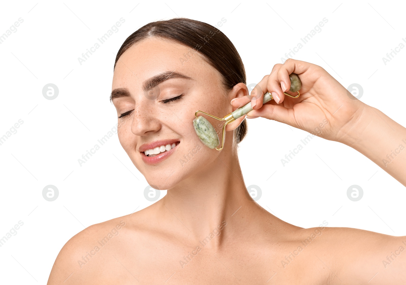 Photo of Beautiful young woman doing facial massage with roller on white background