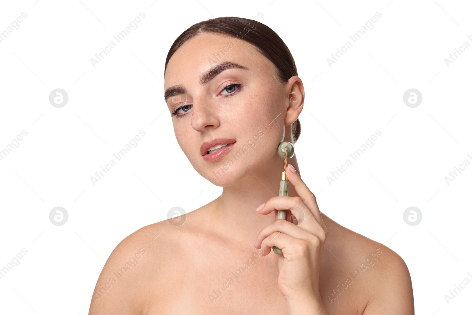 Photo of Beautiful young woman doing facial massage with roller on white background