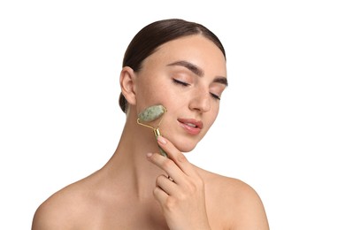 Beautiful young woman doing facial massage with roller on white background