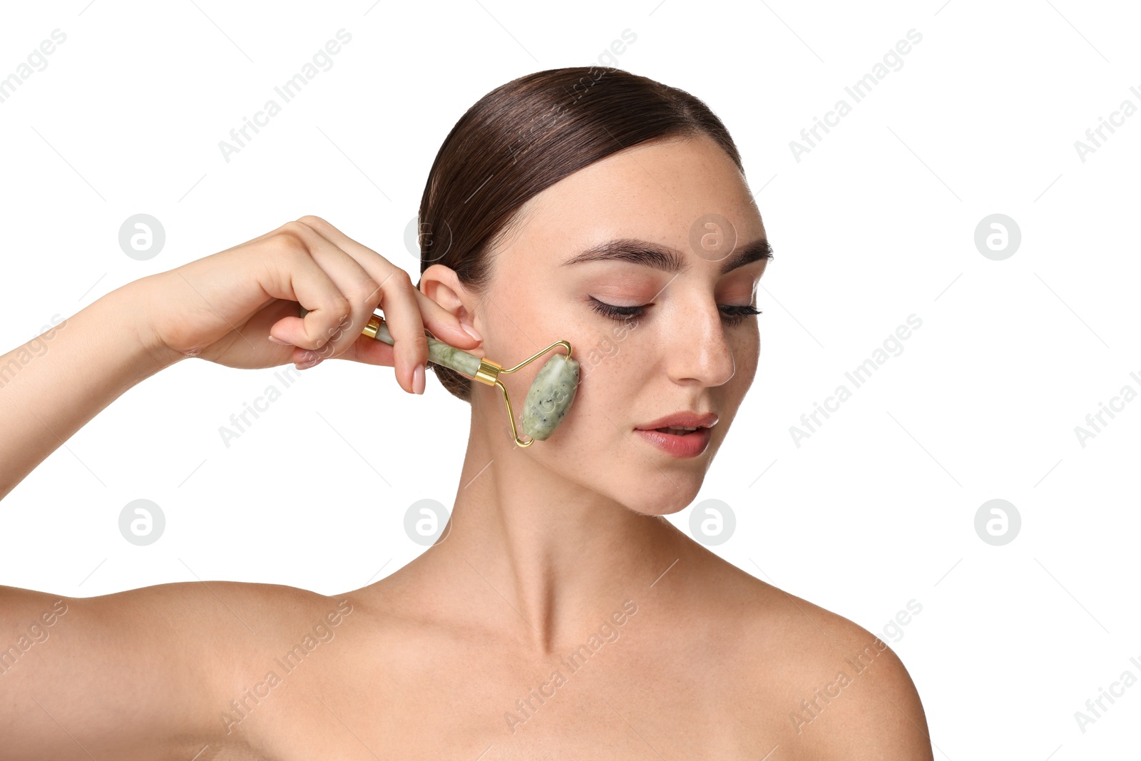 Photo of Beautiful young woman doing facial massage with roller on white background