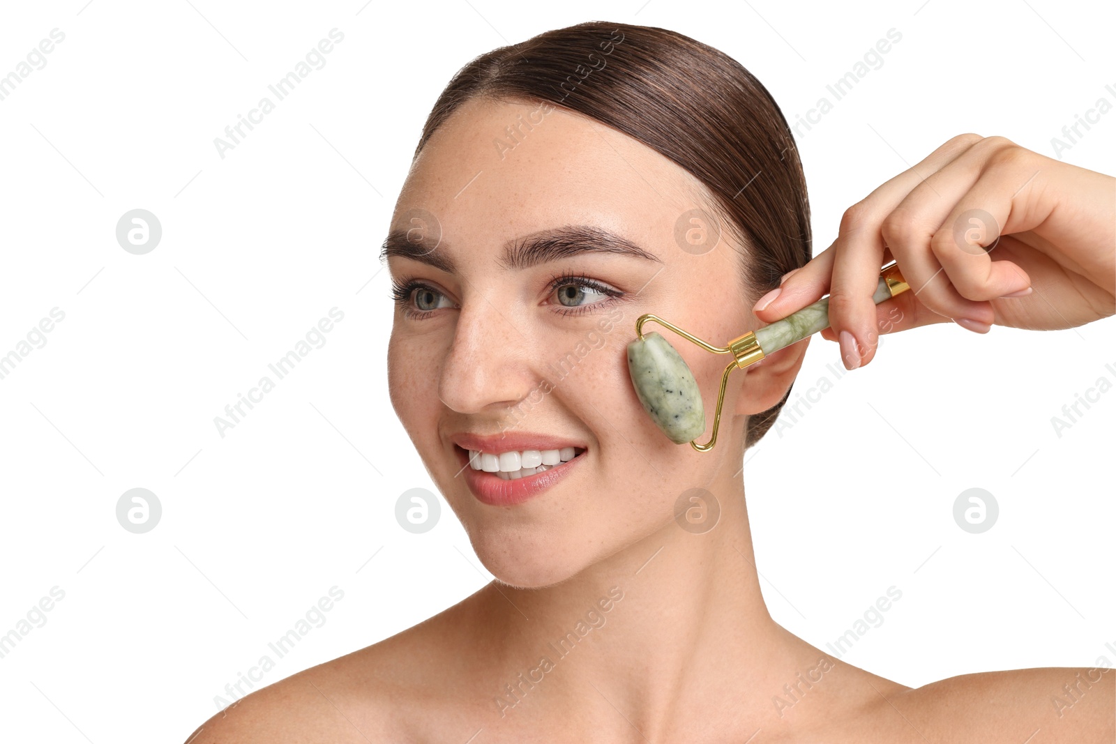 Photo of Beautiful young woman doing facial massage with roller on white background