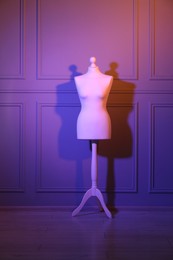 Photo of One mannequin near wall in neon lights