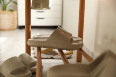 Pair of slippers on shoe rack at home