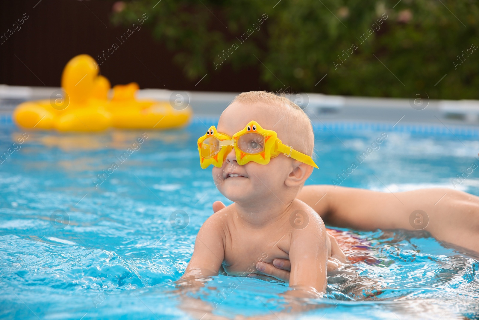 Photo of Father swimming with his son in pool, closeup