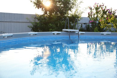 Photo of Above ground swimming pool outdoors on sunny day