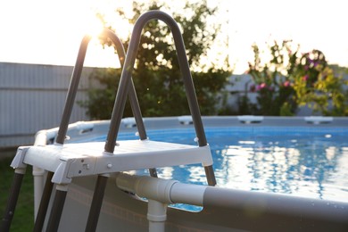 Photo of Above ground swimming pool outdoors on sunny day