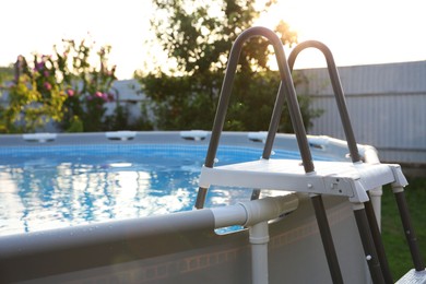 Photo of Above ground swimming pool outdoors on sunny day