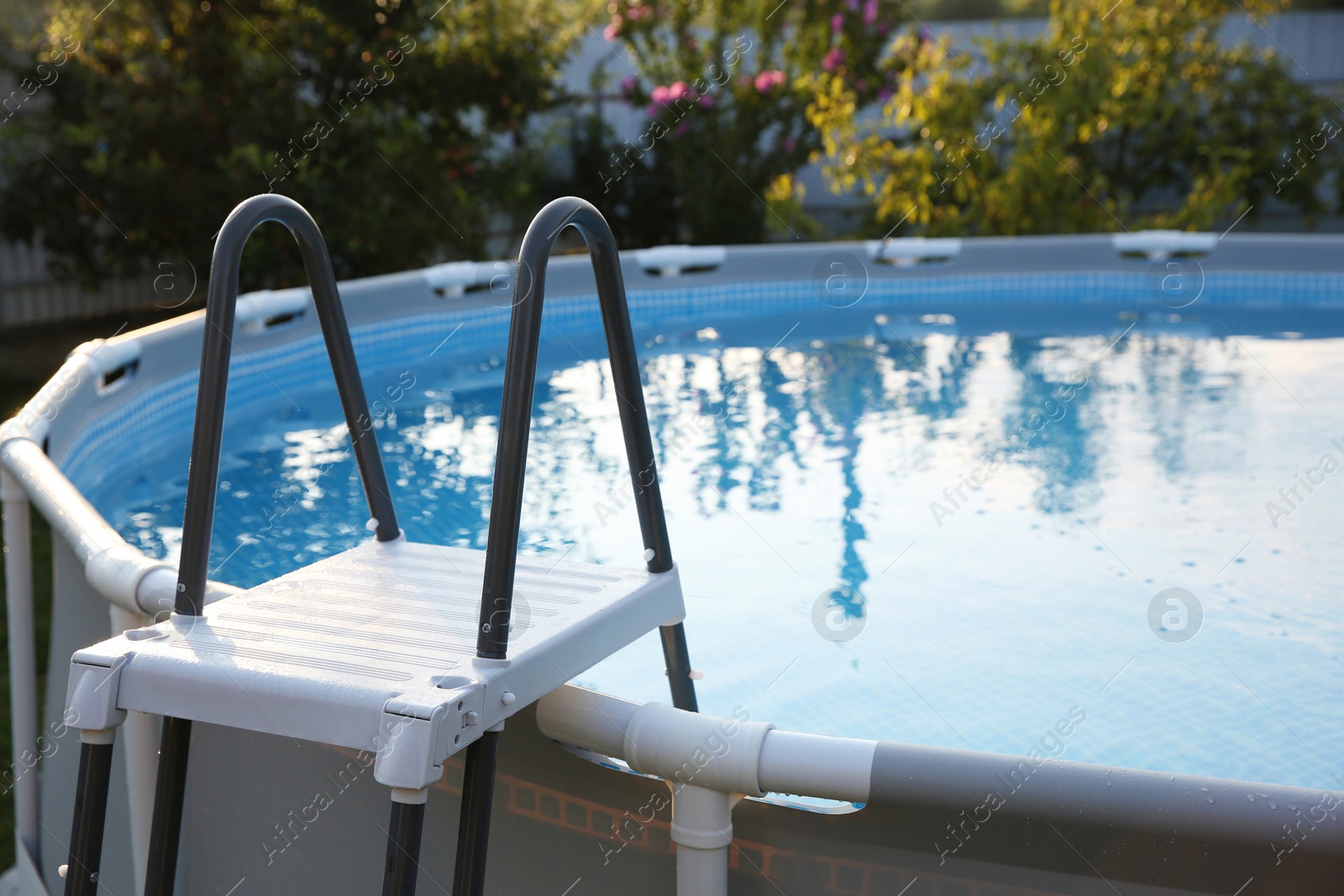 Photo of Above ground swimming pool with ladder outdoors