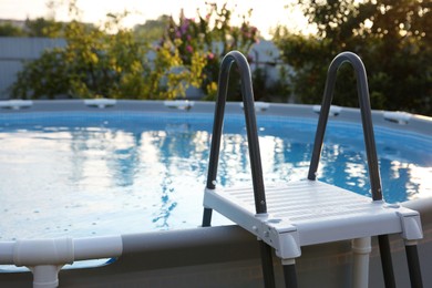 Photo of Above ground swimming pool with ladder outdoors