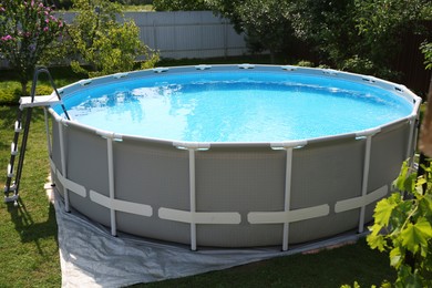 Above ground swimming pool outdoors on sunny day