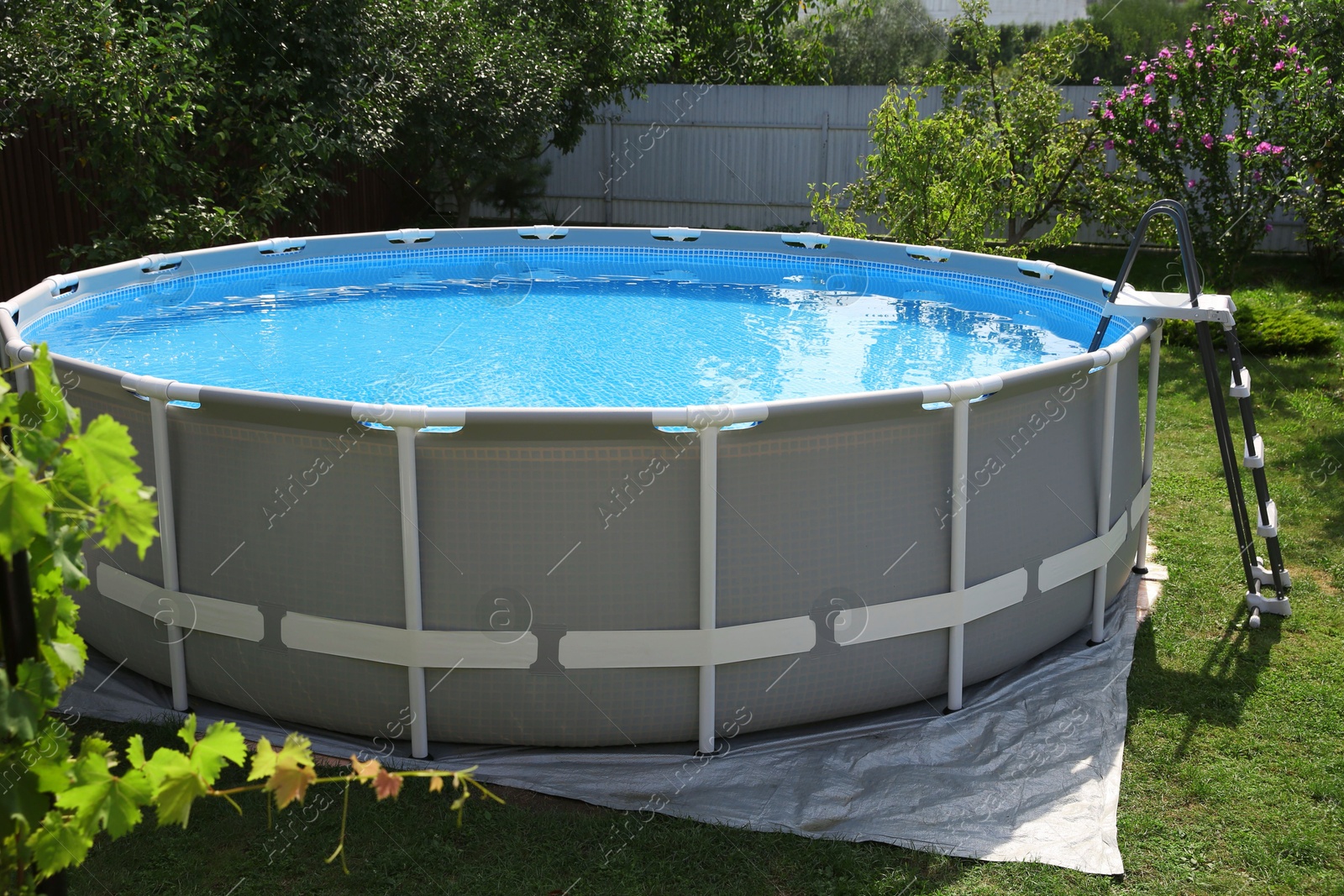 Photo of Above ground swimming pool outdoors on sunny day