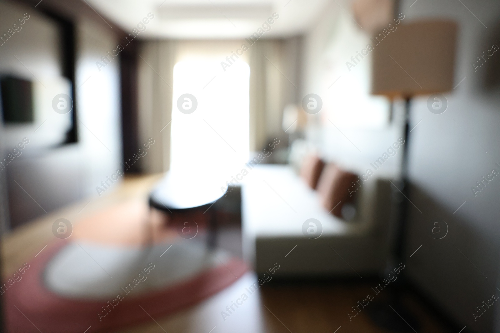 Photo of Blurred view of cozy living room with modern furniture and TV set. Interior design