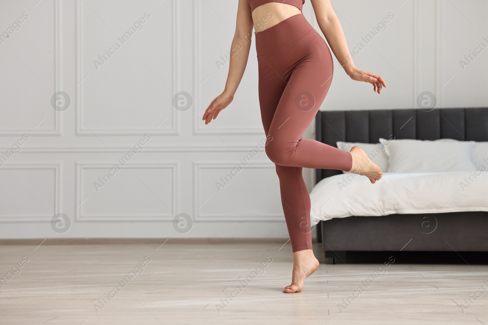 Photo of Woman wearing sports leggings indoors, closeup. Space for text