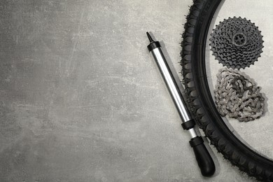 Parts of bicycle and tools on light grey table, flat lay. Space for text