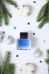 Photo of Christmas composition with perfume bottle on white background, flat lay